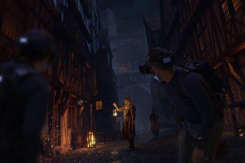 A medieval street with buildings, a statue, and a person wearing a VR headset. 3