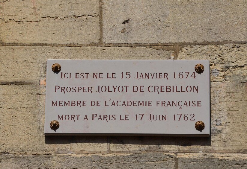A historical plaque on a stone wall. 3