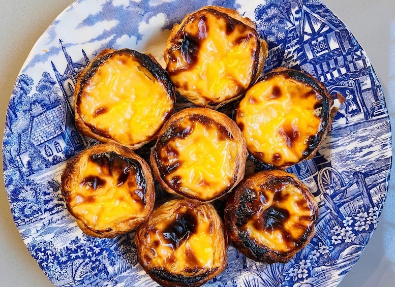 A plate of Portuguese custard tarts with a caramelized top. 1