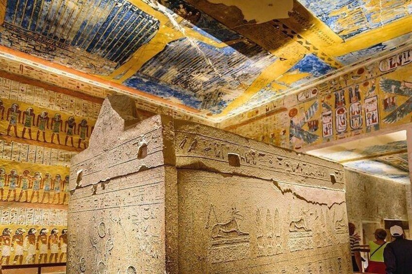 An ancient Egyptian tomb with hieroglyphs and a sarcophagus. 3