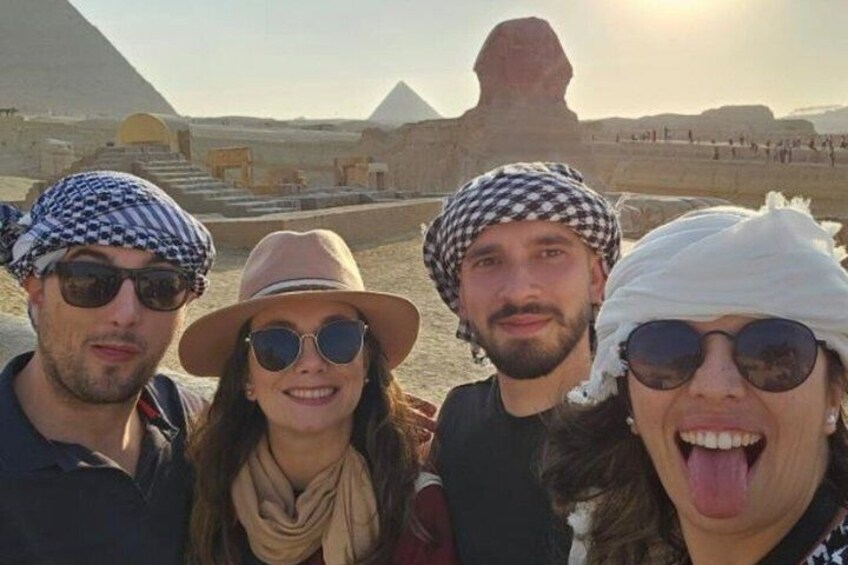 Un grupo de personas frente a la Esfinge de Guiza y las pirámides. 4