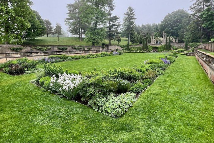 A well-maintained garden with a variety of plants and a stone pathway. 4