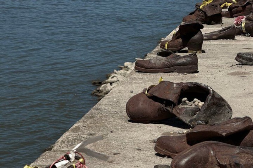 A concrete pier with rows of worn, muddy shoes. 5
