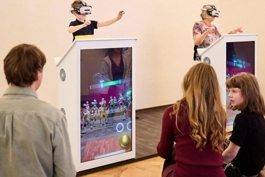 People using VR headsets in an indoor setting with digital displays. 4