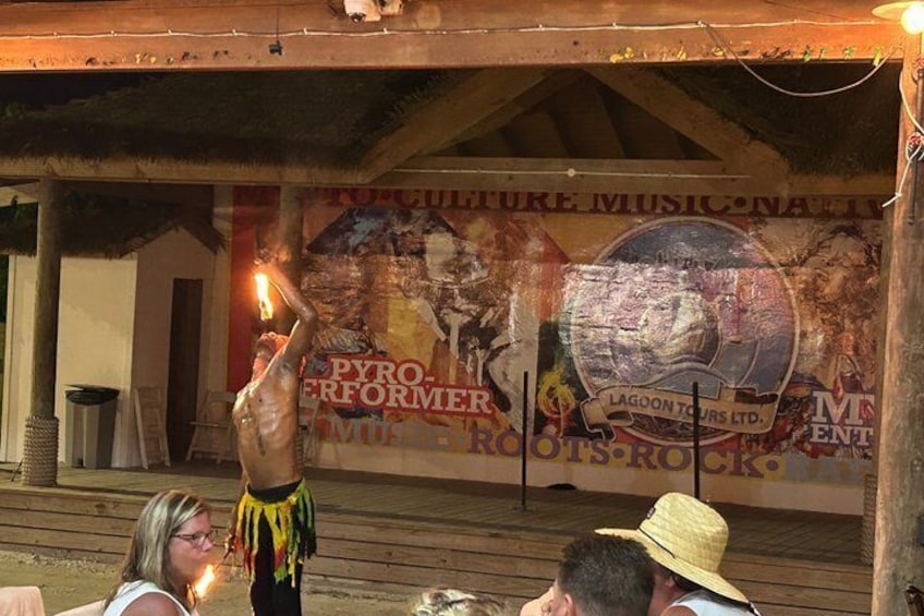 A wooden stage with a banner advertising Pyro-Performers and Lagoon Tours Ltd. 1