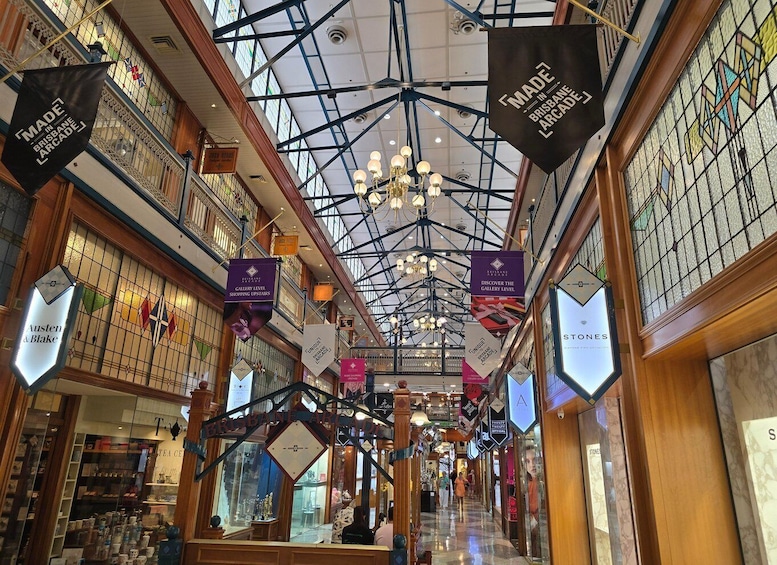 A shopping arcade with glass ceilings and hanging banners. 2