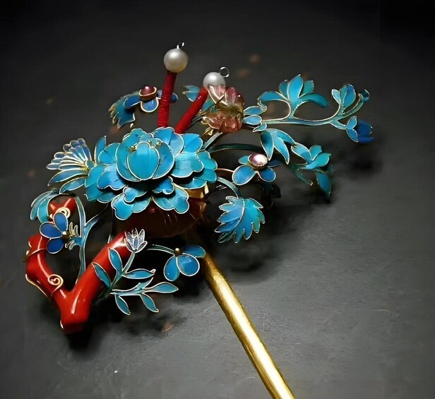 A decorative wand with blue and red floral patterns and a golden handle. 4