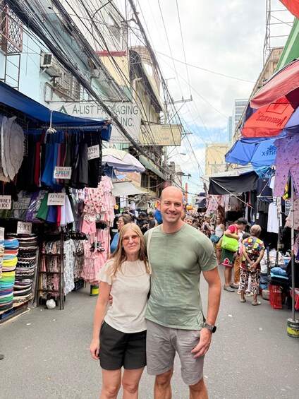 A bustling street market with various stalls selling clothing and accessories. 2