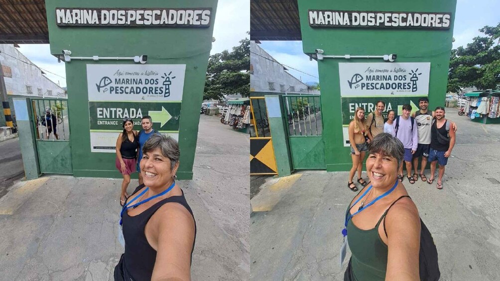 A green entrance gate with signage for 'MARINA DOS PESCADORES' and a directional arrow. 3