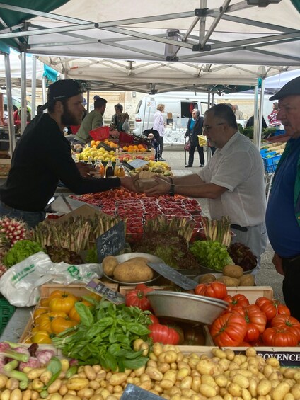 A farmer's market with various vegetables and fruits on display. 5