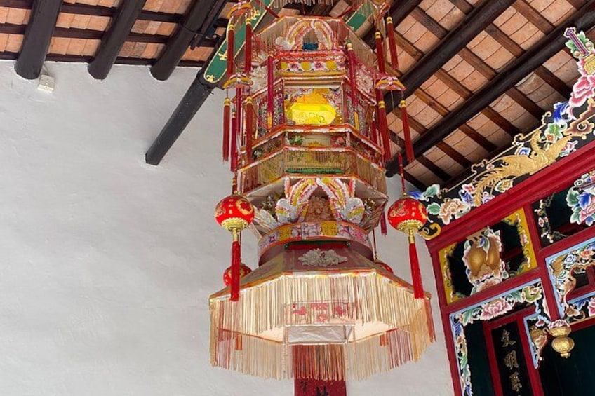 A traditional Chinese lantern with intricate designs and tassels. 5