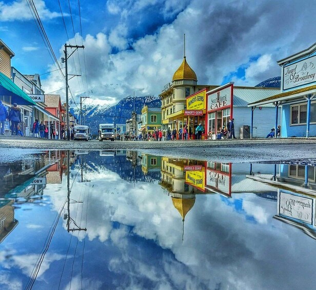 A town with colorful buildings, a clear sky, and a mountain in the background. 1