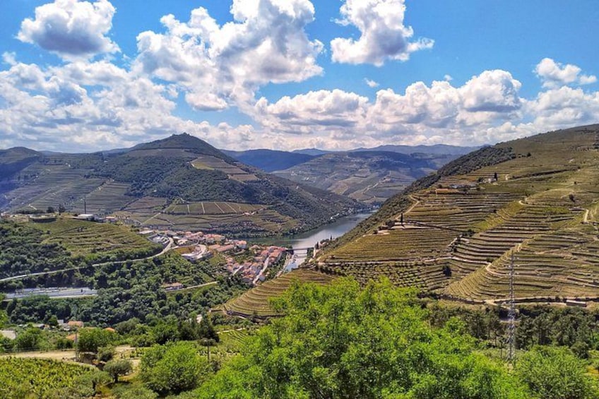 Terraced vineyards, a river, and rolling hills. 4