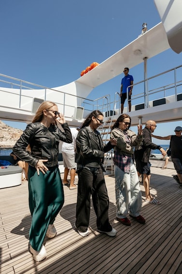 People on a boat deck with a clear sky. 3