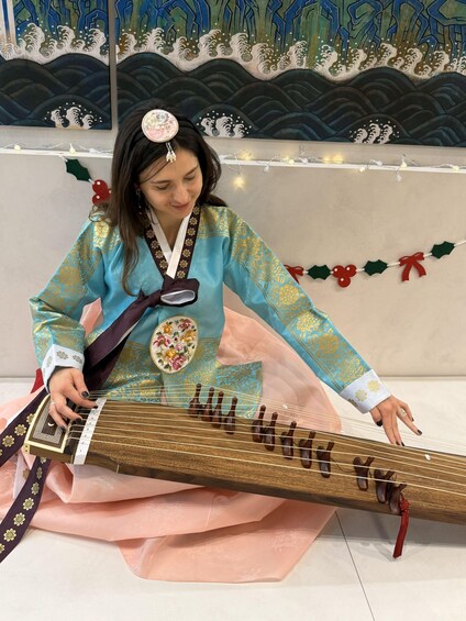 A person playing a traditional stringed instrument. 3