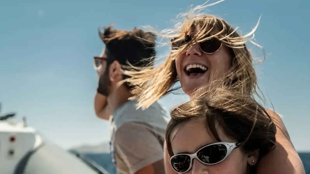 Two people on a boat with a clear sky in the background. 1