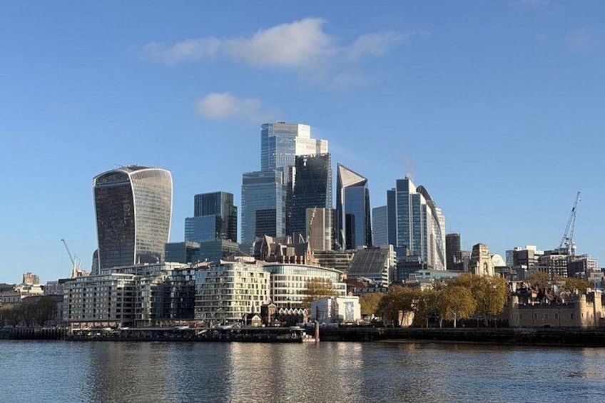 A city skyline with modern buildings, a river, and a construction crane. 3