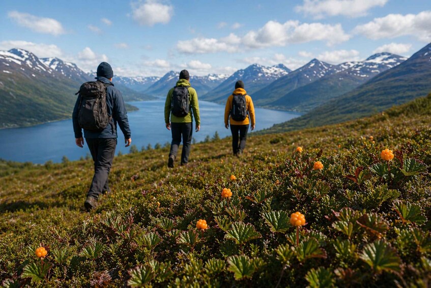 Three hikers on a mountainous trail with a lake in the background. 3