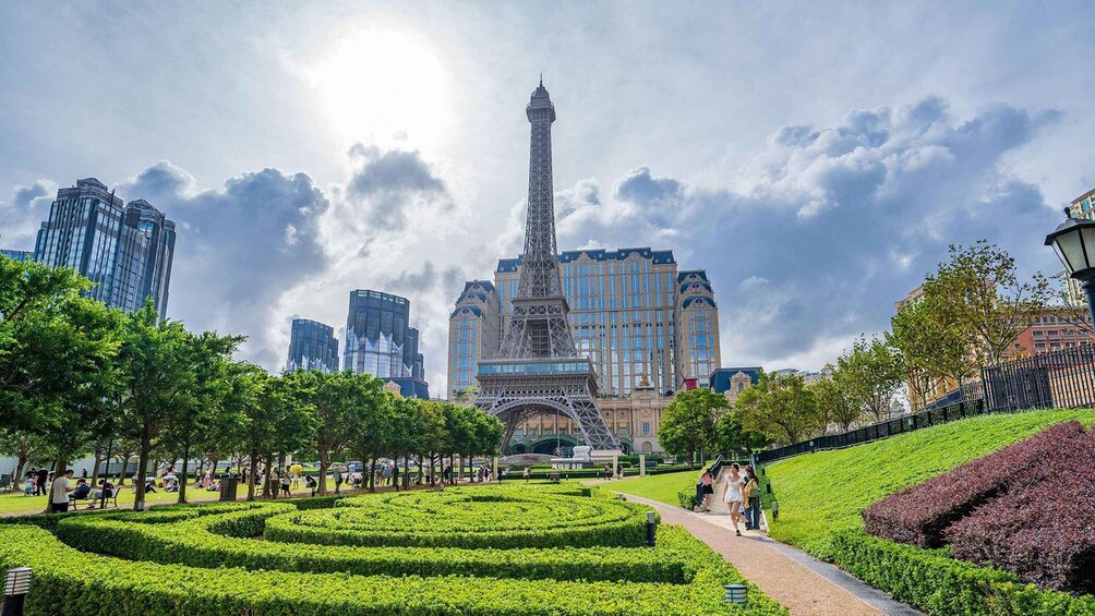 The Eiffel Tower in Paris, surrounded by lush green gardens and modern buildings. 4
