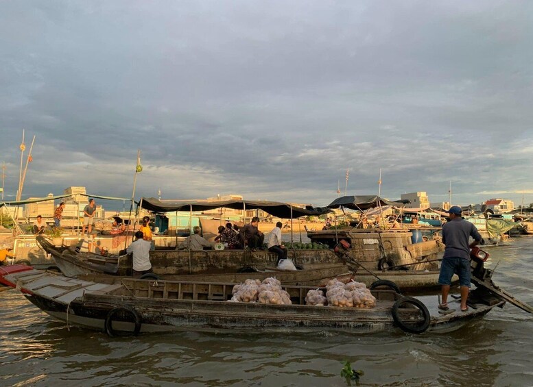 A crowded waterfront with boats, people, and buildings. 4