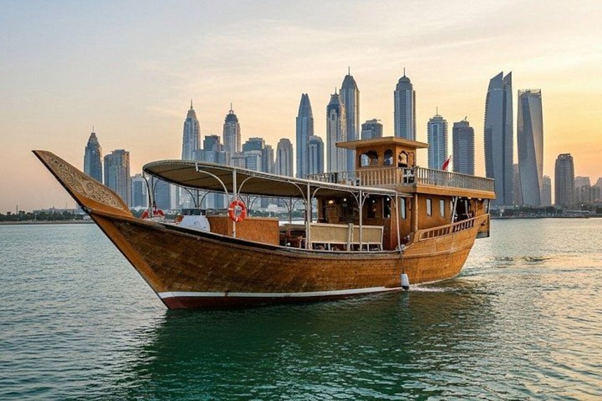 A traditional wooden boat on water with a city skyline in the background. 2