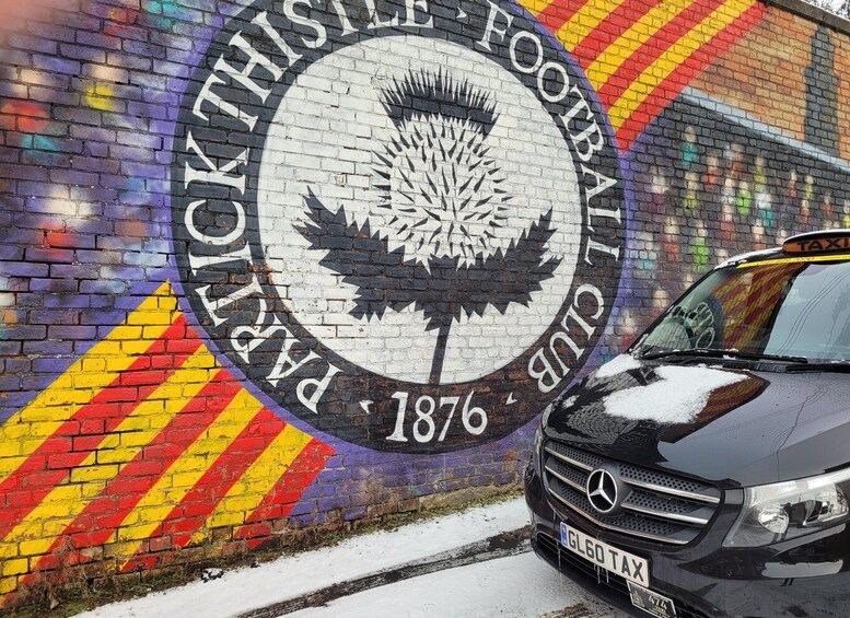 A mural of a thistle with the text 'Pickthistle Football Club 1876' on a brick wall. 4