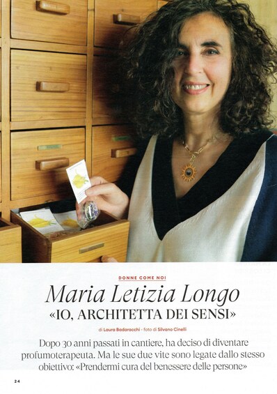 A person holding a card in front of a wooden cabinet. 2