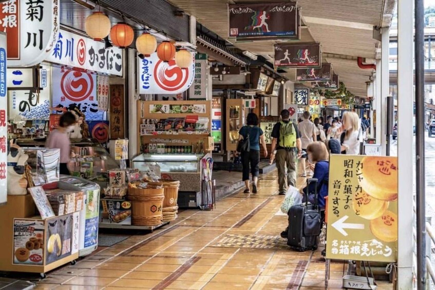 A bustling indoor market with various stalls and signs in Japanese. 3