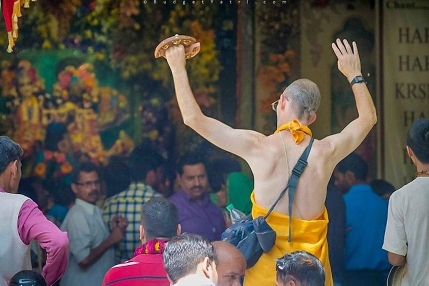 A person in traditional attire with raised arms, possibly performing a ritual or celebration. 1