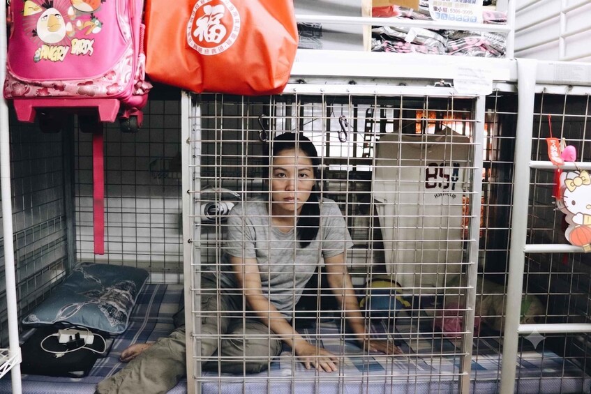 A person inside a metal cage with a Hello Kitty decoration on the right. 1
