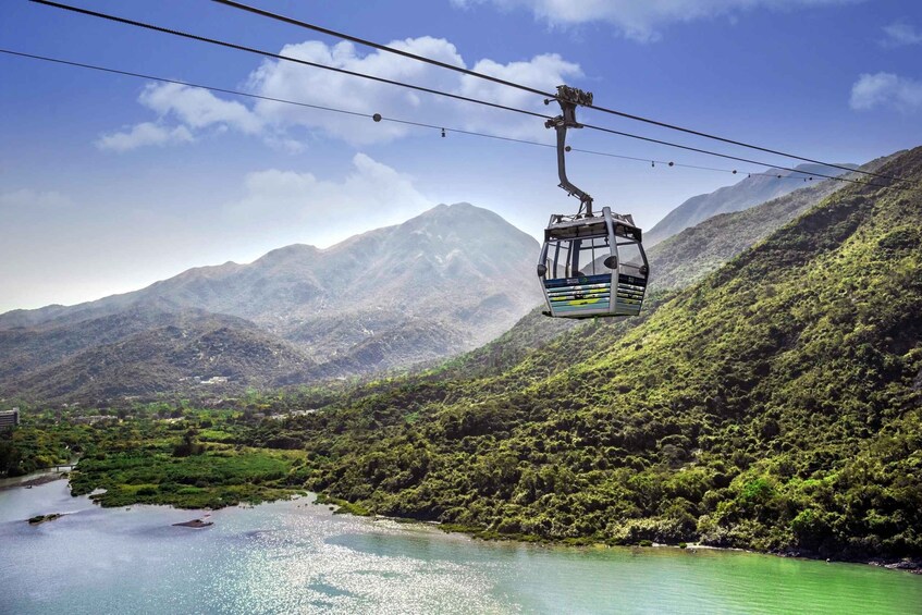 A cable car over a river with mountains in the background. 2