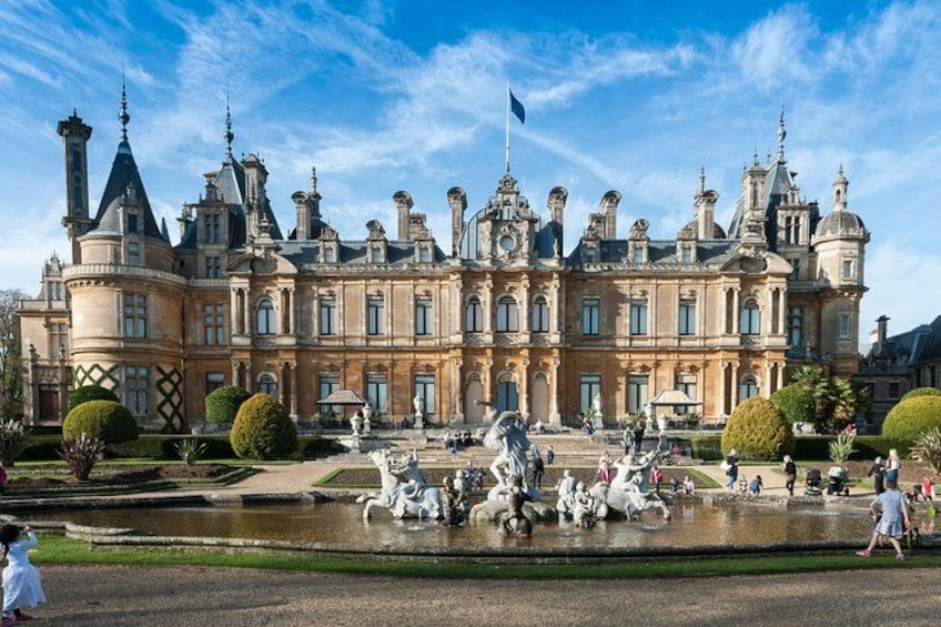 A grand historic building with a large courtyard and a fountain. 1