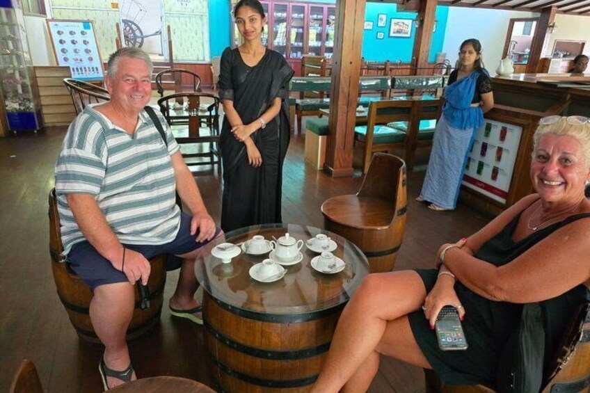 A group of people in a rustic interior with wooden barrels, tables, and chairs. 5