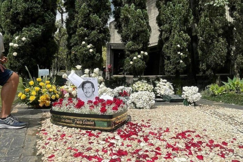 Un monumento con flores y un retrato. 2