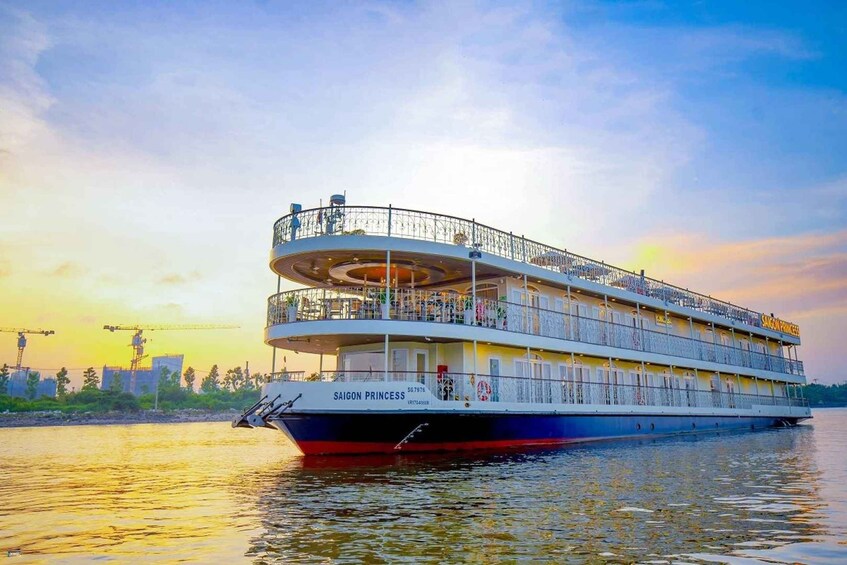 A riverboat named 'Saigon Princess' with a multi-deck design, featuring a covered upper deck and a lower open deck. 1