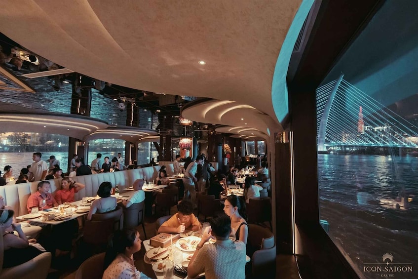 A restaurant with tables and chairs, a view of a bridge, and a body of water. 3