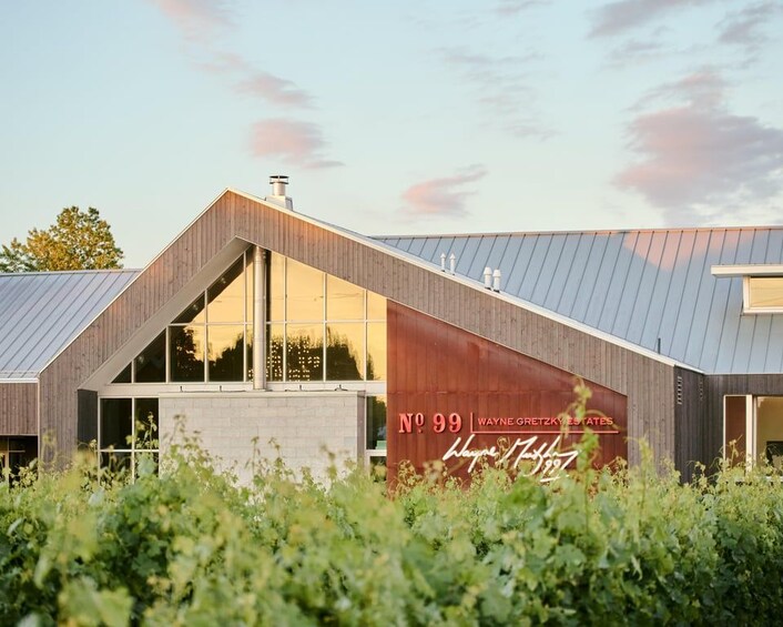 A modern building with a sloped roof and large windows, labeled 'No 99 Wayne Gretzky Estates.' 5