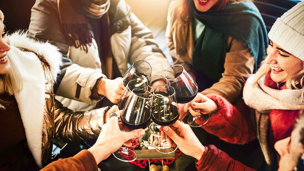 A group of people toasting with wine glasses. 1