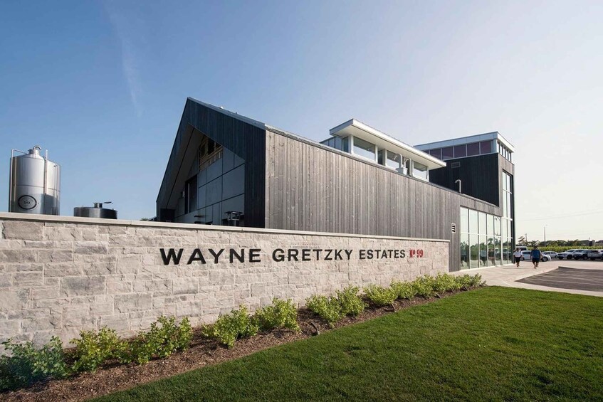 A modern building with a stone wall labeled 'WAYNE GRETZKY ESTATES.' 4