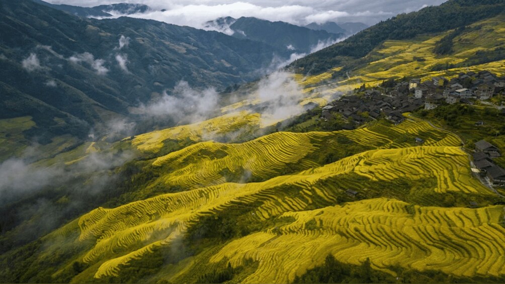 Terraced fields, a mountain range, and a village. 3