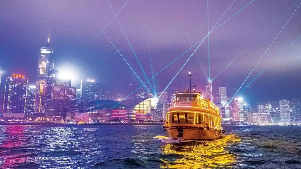 A boat on water with a city skyline in the background. 1