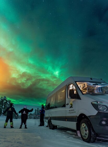 A snow-covered landscape with a vehicle labeled 'WILDERNESS HOTELS & SAFARIS' and people in winter attire. 1