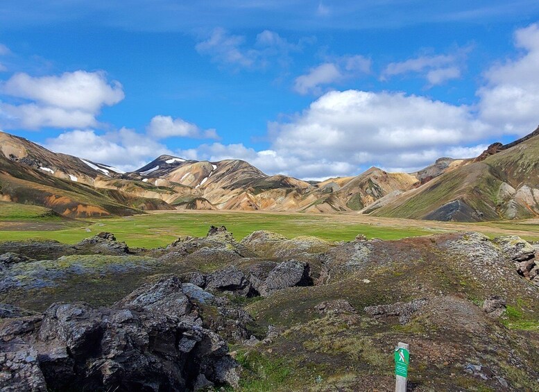 A mountainous landscape with green valleys and rocky outcrops. 2