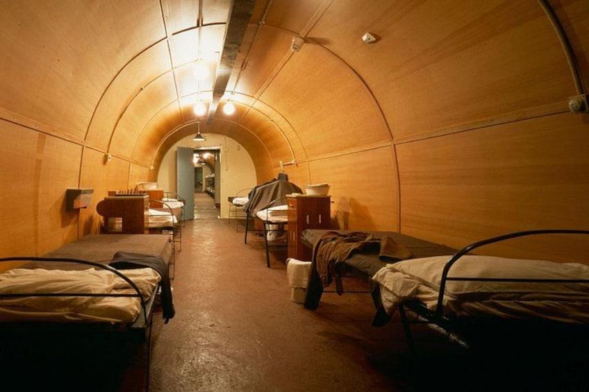 A tunnel with bunk beds and tables. 2