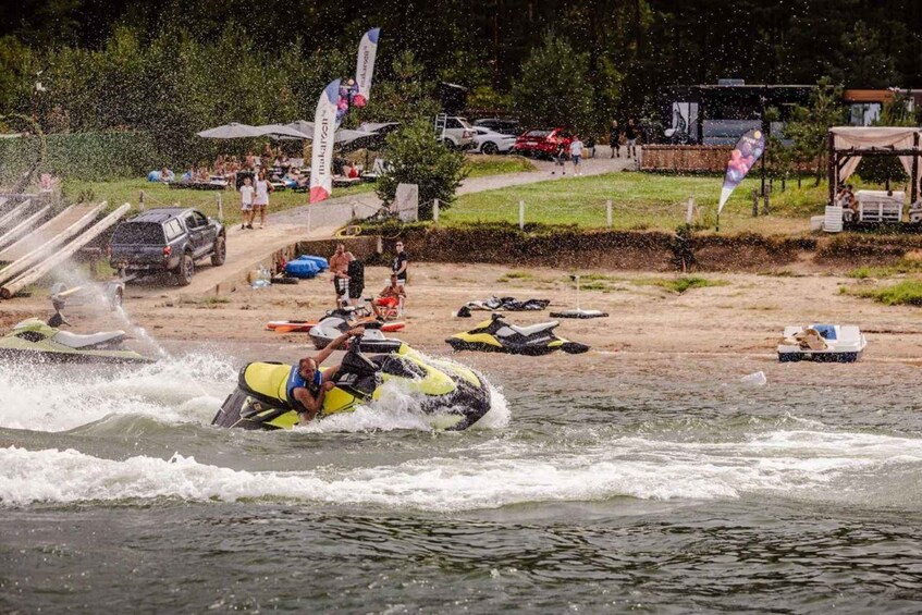 A water sport event with a person riding a yellow watercraft. 4