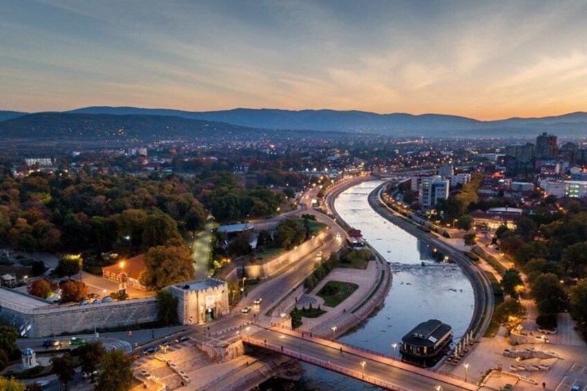 A river flowing through a city with bridges and roads. 2