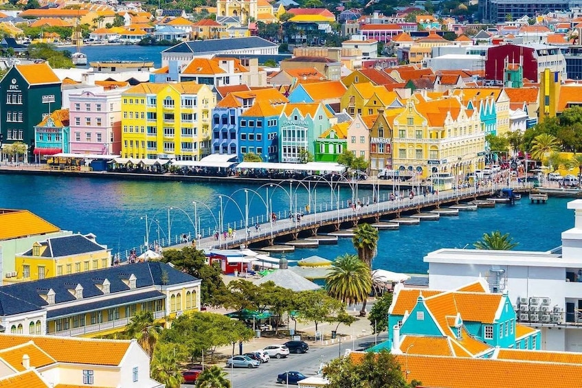 A colorful coastal town with a prominent pier and waterfront buildings. 1