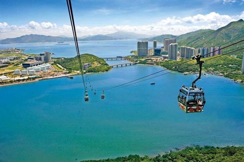 A cable car system over a body of water with a cityscape in the background. 5