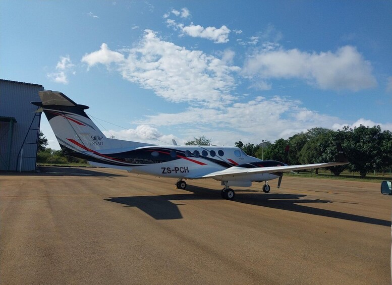 A private aircraft with registration ZS-PCH parked on a tarmac. 3