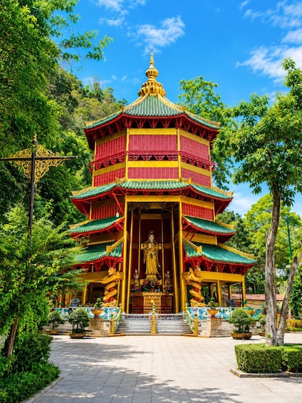 A multi-tiered temple with a golden statue in the entrance. 4